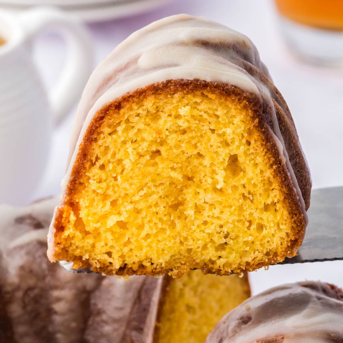 Shot of the side of a piece of rum cake on a spatula.