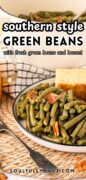 This is a closeup shot of a plate of Southern Style green beans with bacon, plated with cornbread.