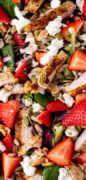 Strawberry Salad with poppy dressing is featured from over head in this closeup image.