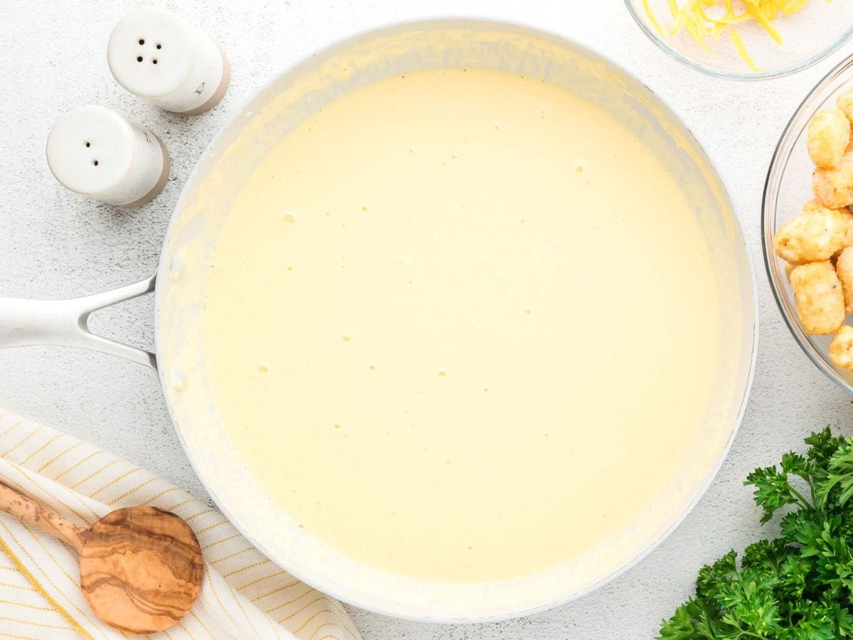 Overhead shot of finished cheese sauce in a skillet.