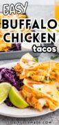 Easy Buffalo Chicken Tacos are plated and served with lime wedges.