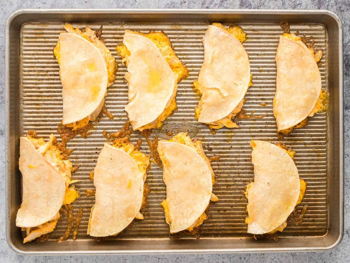 Buffalo chicken tacos on a sheet pan after being baked.