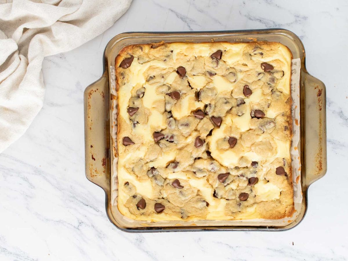 Cookie dough cheesecake bars i a baking pan after being baked.