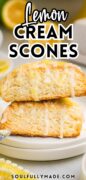 2 Lemon Cream Scones are stacked on a stack of white plates.