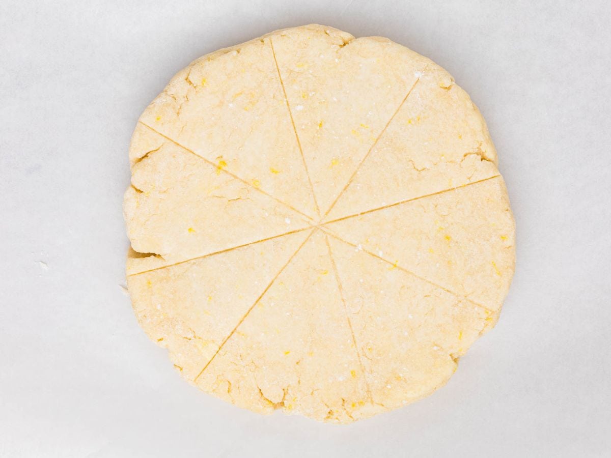 Disc of scone dough with indentations to slice 8 triangles.