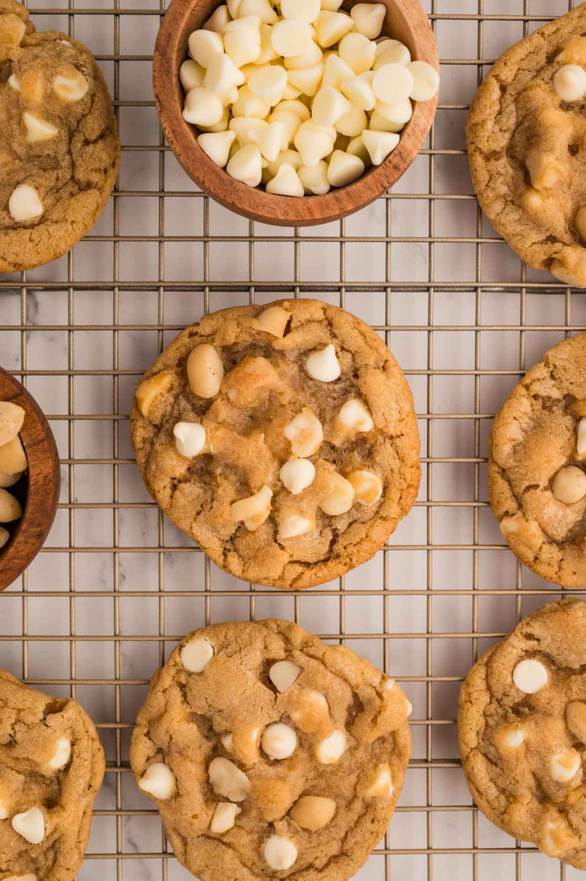 White chocolate macadamia nut cookies on a cooling rack after being baked.