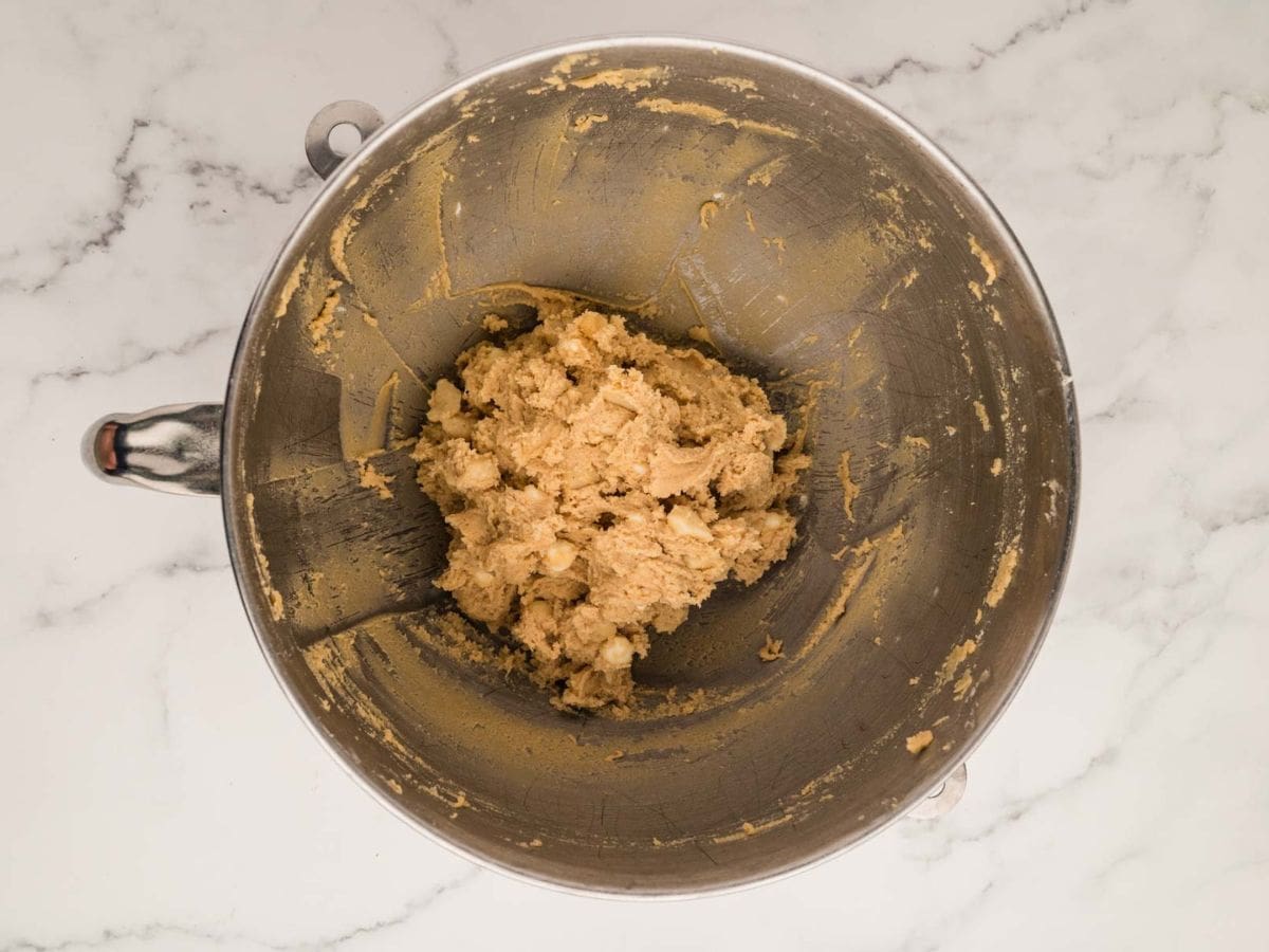 Cookie dough in the bowl of a stand mixer.