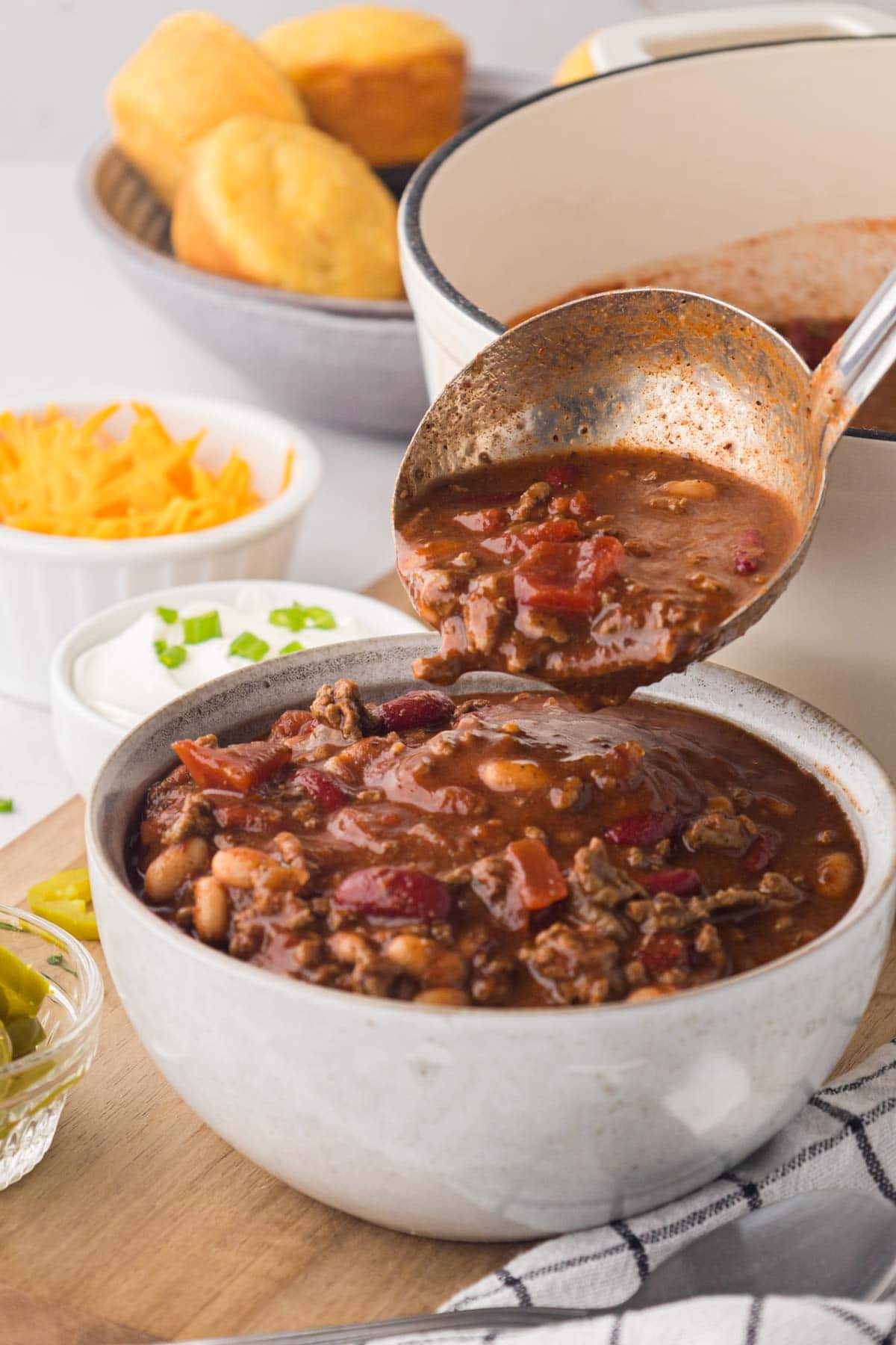 Needling chili made with bloody Mary mix into a serving bowl.