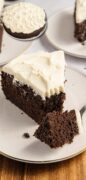 The dark and rich Chocolate Stout Cake is plated on a whilte plate with a fork.