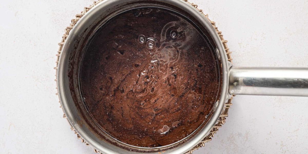 Melting the butter with Guinness beer in a saucepan.