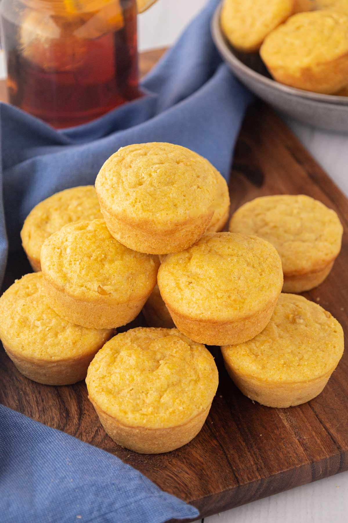 Sweet Southern cornbread muffins on a wooden serving board.