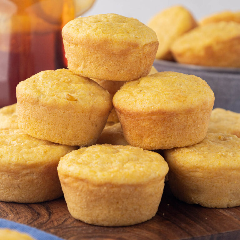 Sweet Southern cornbread muffins on a wooden serving board.