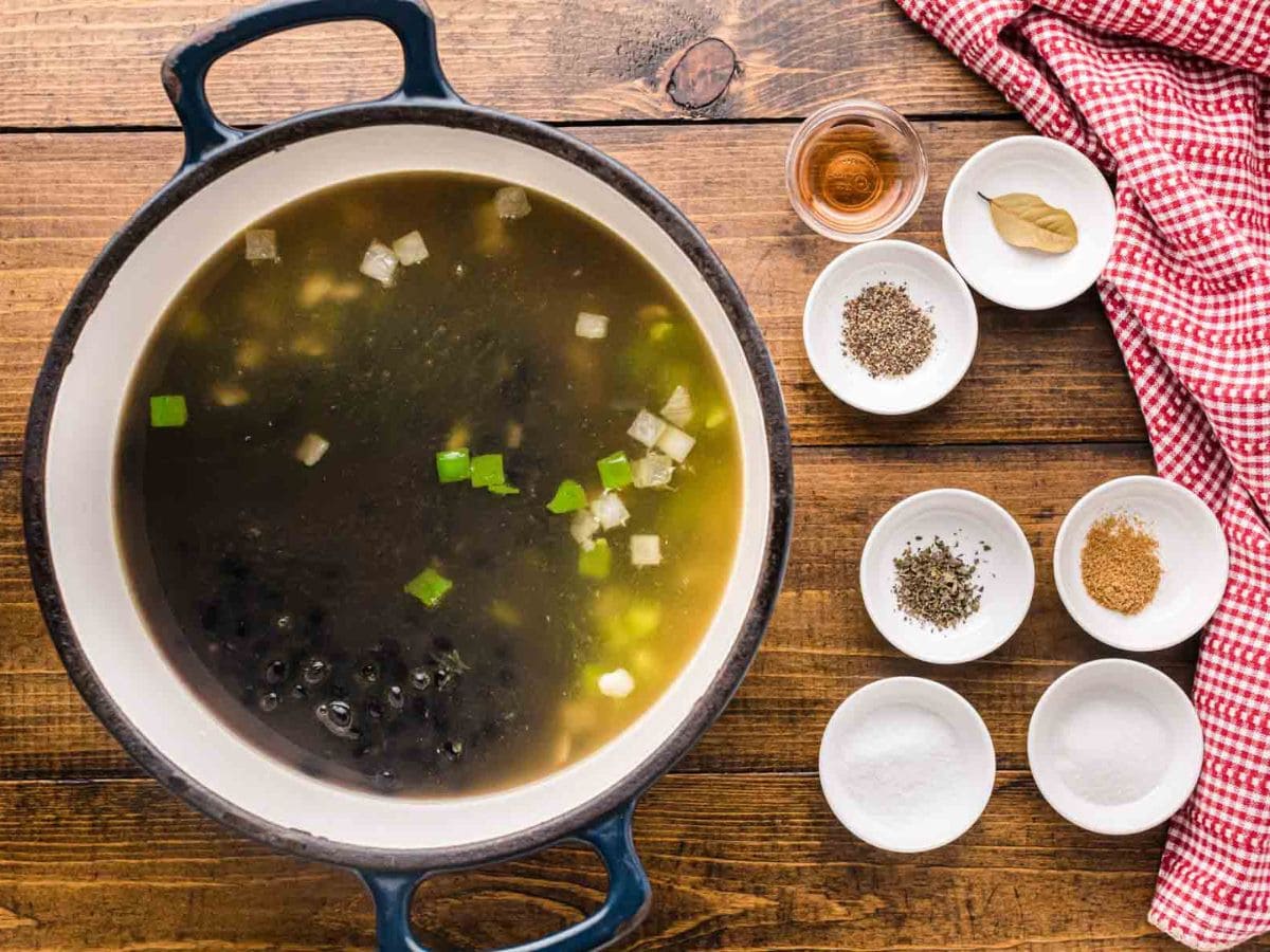 Black beans with broth in a pot.