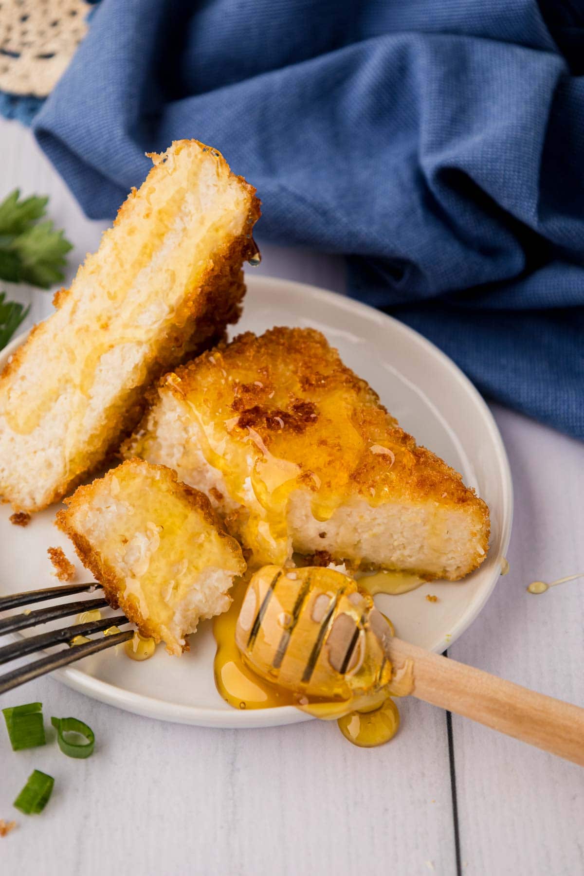 A grit cake sliced with honey drizzled on top.