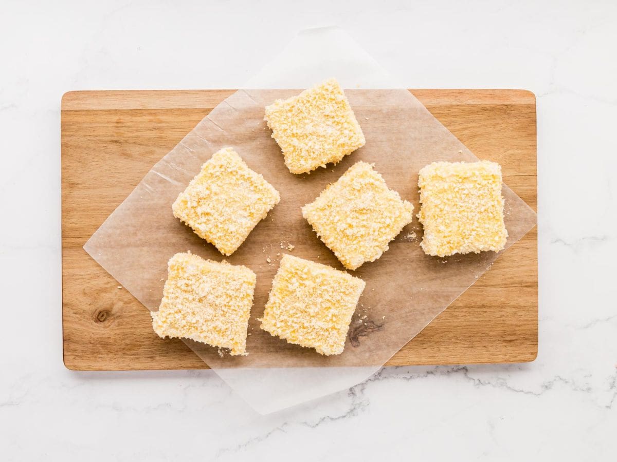 Panko coated grit cakes on wax paper.