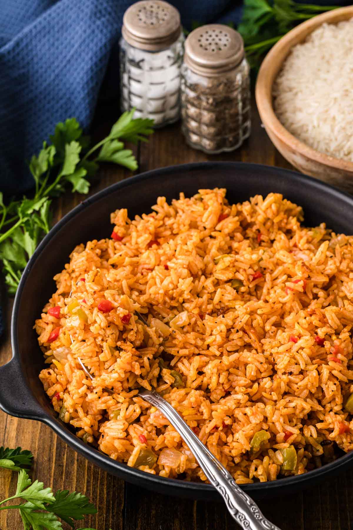 Yellow rice in a black serving dish.