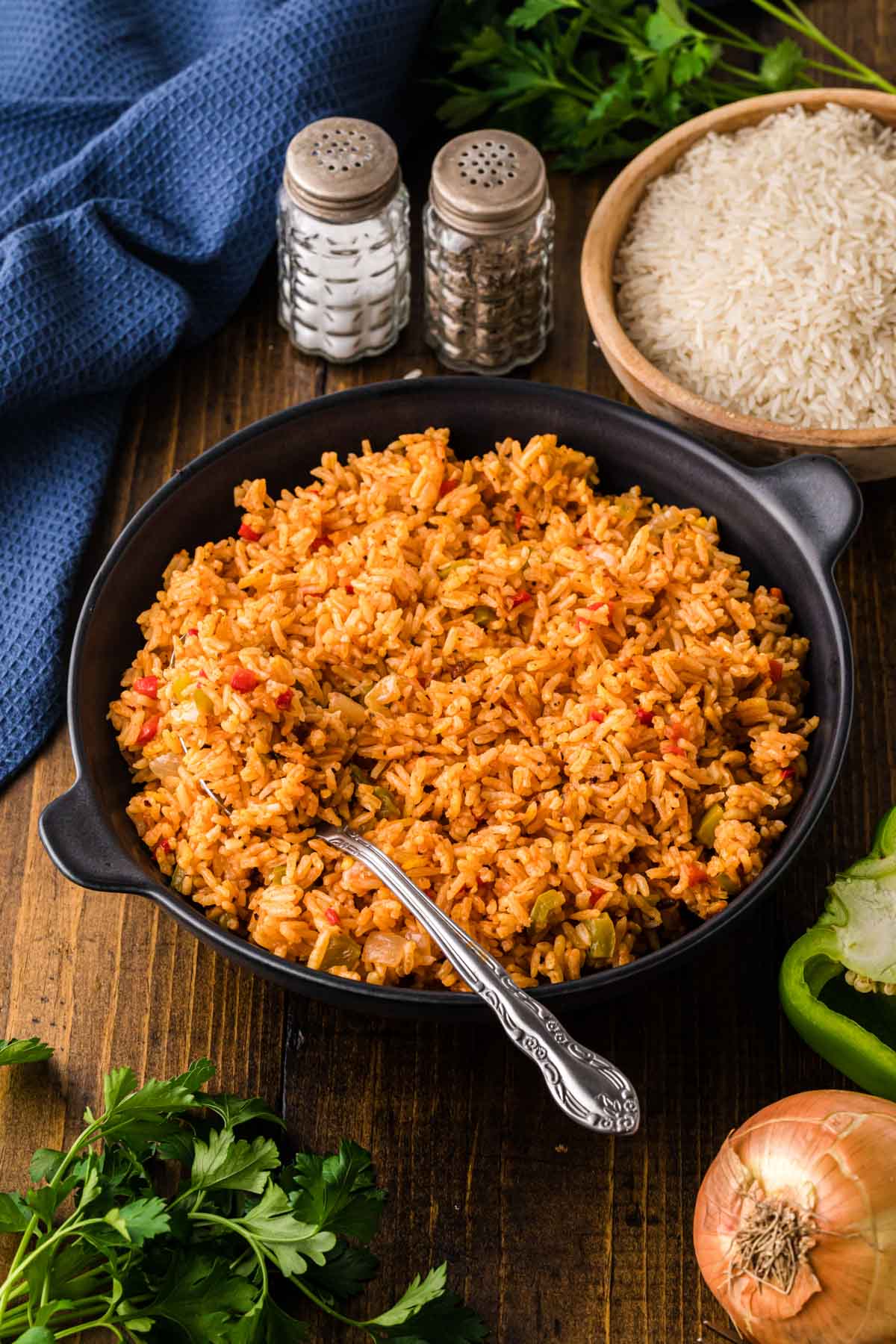 Yellow rice in a black serving dish.