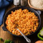 Yellow rice in a black serving dish.