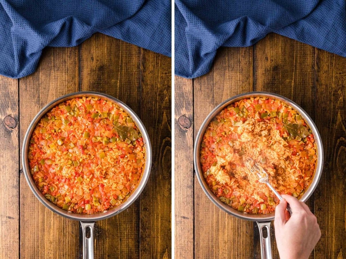 Cooked yellow rice in the skillet and using a fork to fluff it.