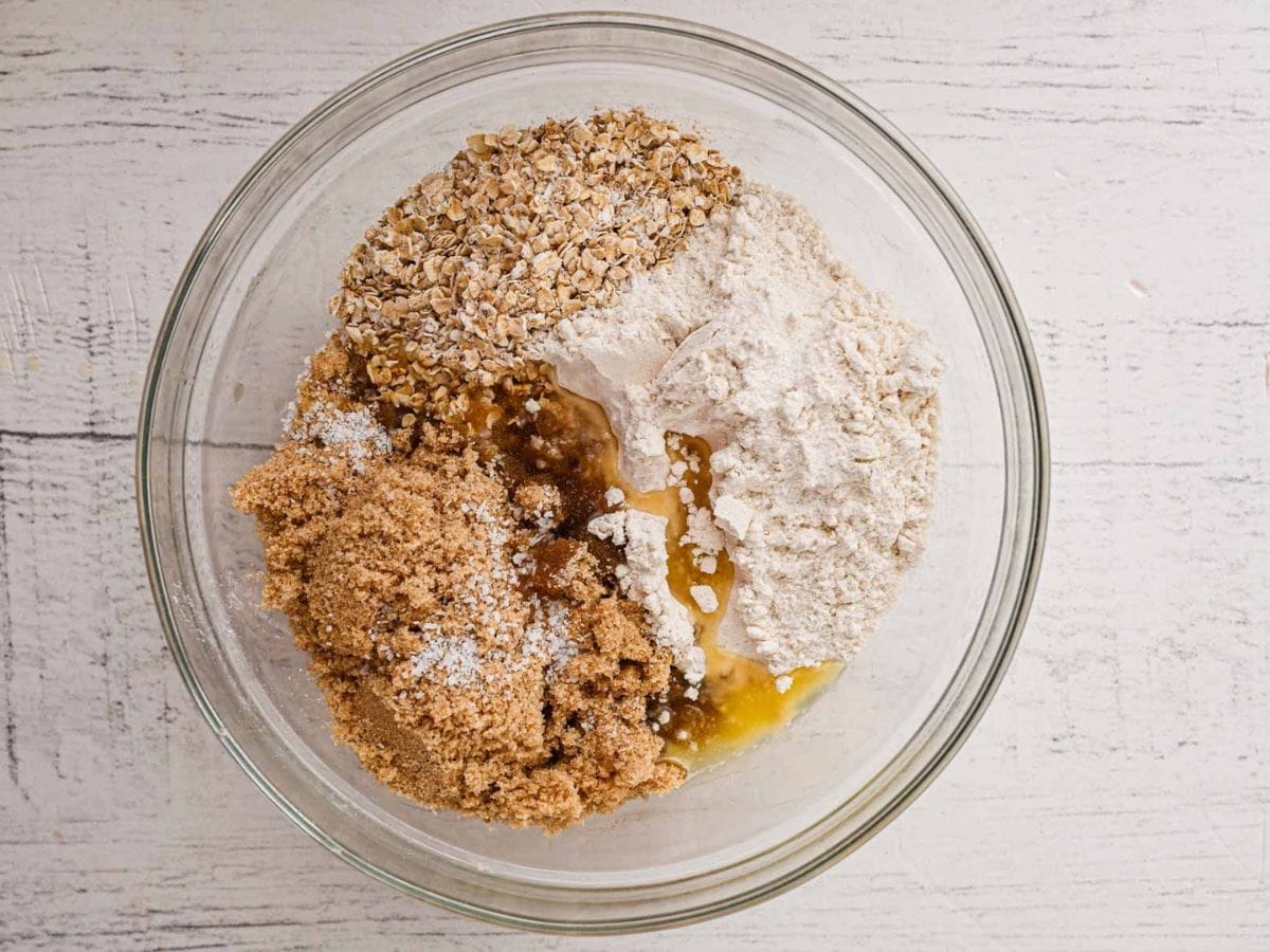 Ingredients for the crumble layer in a glass mixing bowl.