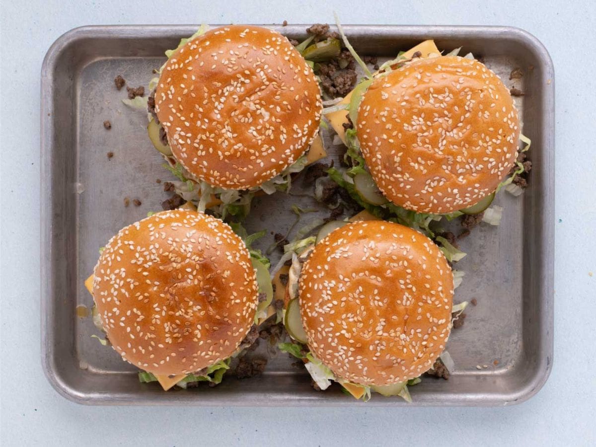 Overhead shot of four big mac sloppy joes on a sheet pan.