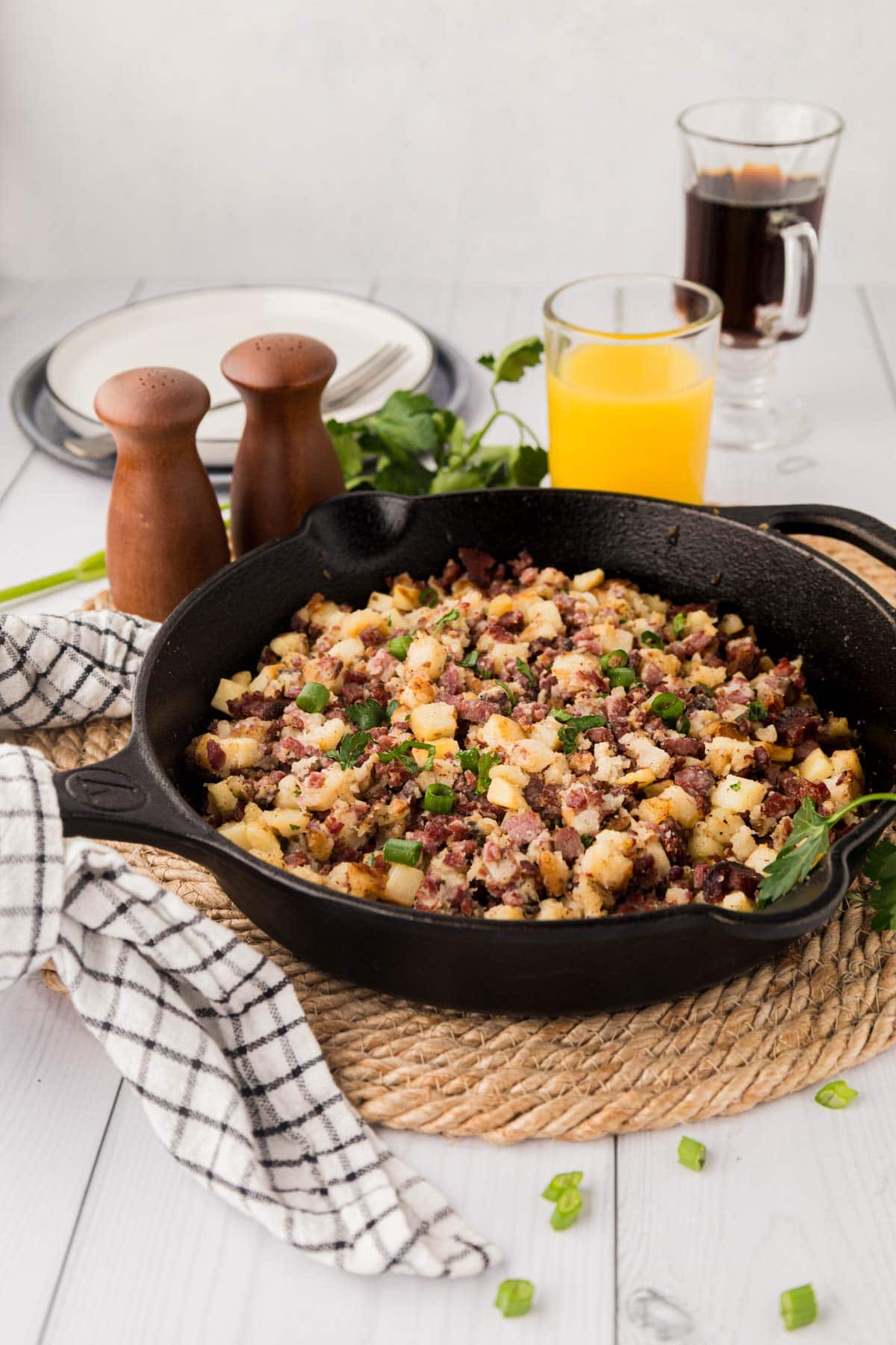 Corned beef has in a cast iron skillet on a table.