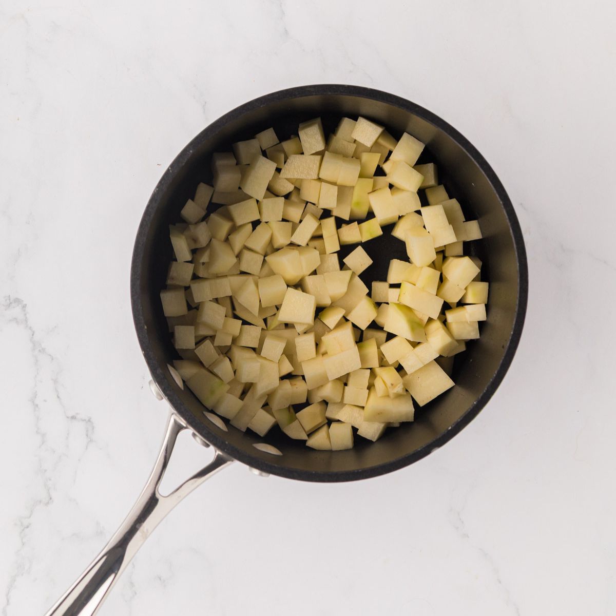 Diced potatoes in a saucepot.