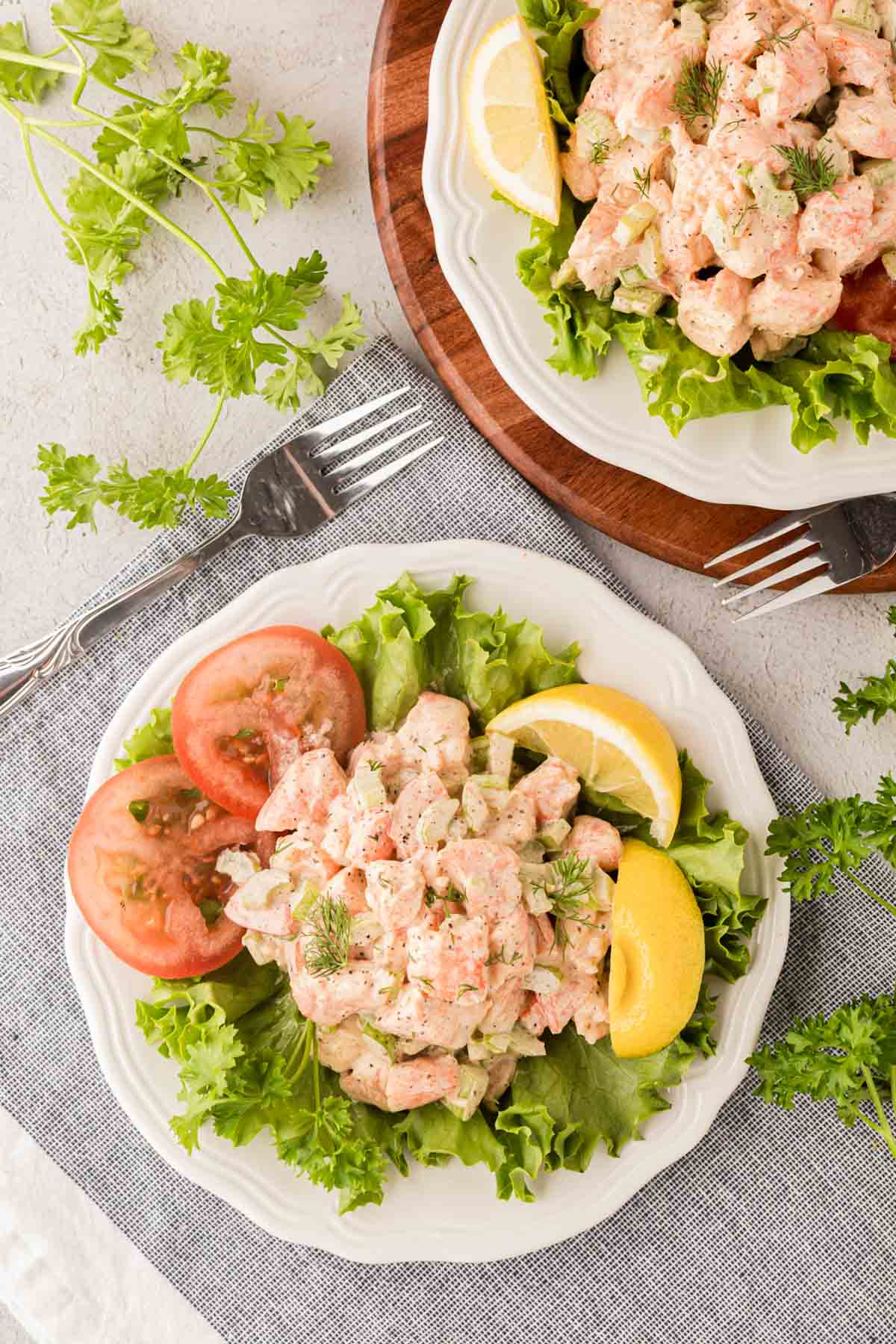 A shrimp salad sat on a bed of lettuce.